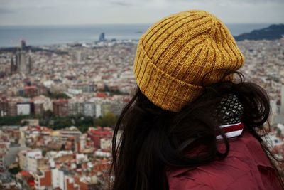 Rear view of woman looking at cityscape