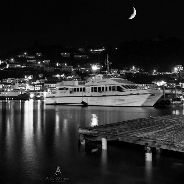 illuminated, night, architecture, built structure, building exterior, water, river, city, reflection, waterfront, sky, cityscape, lighting equipment, sea, residential building, street light, outdoors, moon, no people, residential structure