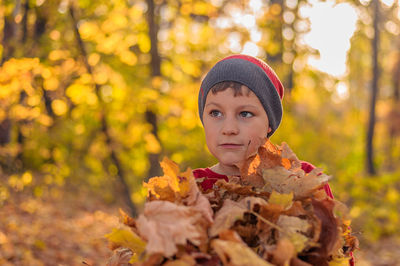 Portrait of man with autumn leaves