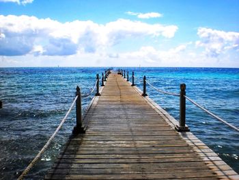Pier over sea against sky