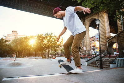 Man skateboarding on skateboard in city