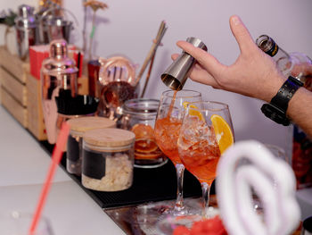 Hands of men preparing drink at bar