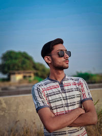 Young man wearing sunglasses standing outdoors