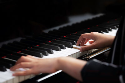 Midsection of man playing piano