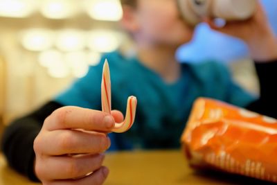 Close-up of boy holding candy