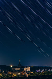 Illuminated city against clear sky at night