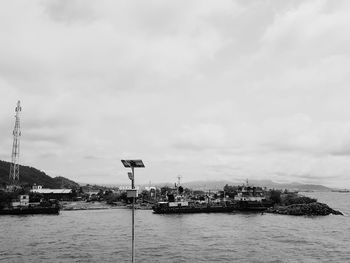Scenic view of sea by buildings against sky