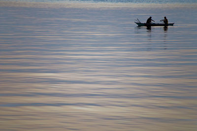 People in boat on lake