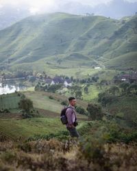 Man looking at mountain landscape