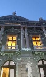 Low angle view of illuminated building against clear sky