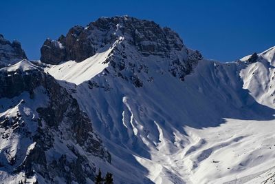 Scenic view of snowcapped mountains against clear sky