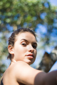 Portrait of teenage girl exercising in park