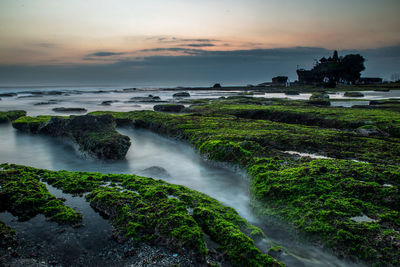 Scenic view of sea against cloudy sky