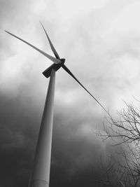 Low angle view of windmill against sky