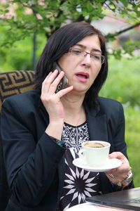 Young woman holding coffee cup