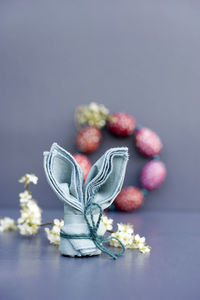 Close-up of purple flower on table against white background