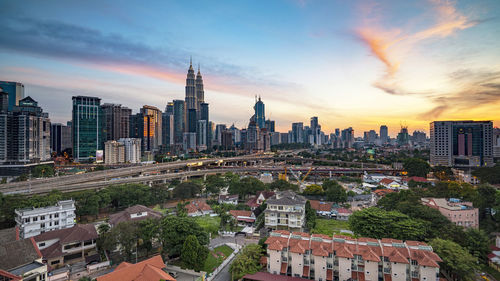 View of cityscape against cloudy sky