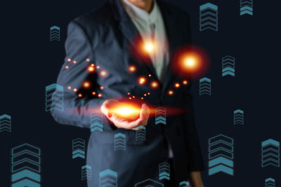 Digital composite image of hand holding illuminated lighting equipment at night