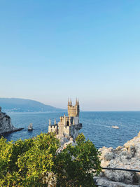 Scenic view of sea against clear blue sky