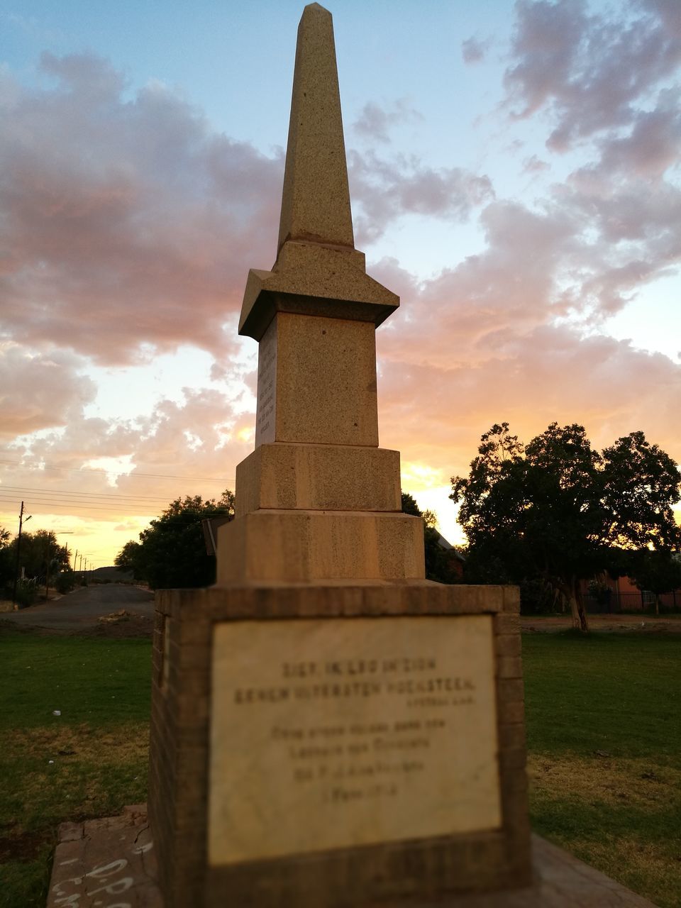 cloud - sky, memorial, cemetery, text, sky, tree, sunset, grass, outdoors, architecture, no people, built structure, nature, gravestone, day