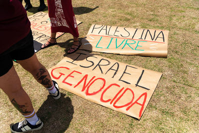 Posters are seen on the ground with words against the war in palestine during a protest 