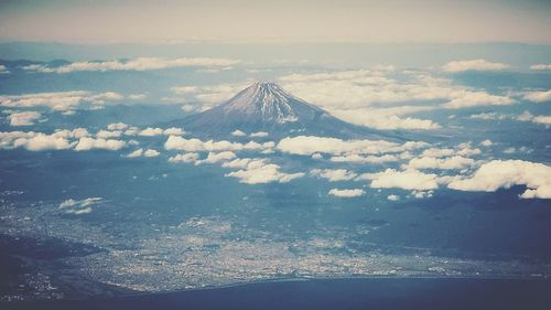 Aerial view of snowcapped mountains against sky