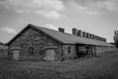 Abandoned house on field against sky