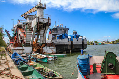 Ship moored on sea against blue sky