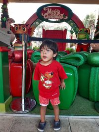 Portrait of smiling boy standing outdoors