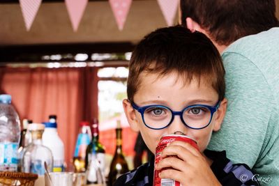 Portrait of boy drinking coffee