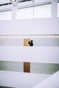 Rear view of woman walking in corridor