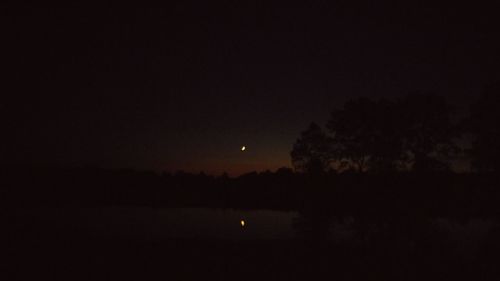 Scenic shot of calm lake at sunset