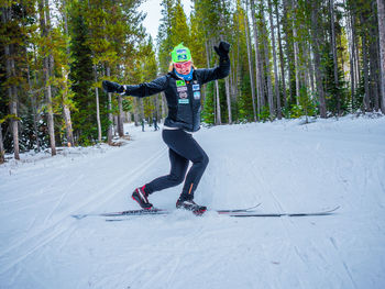 Woman with arms outstretched on snow