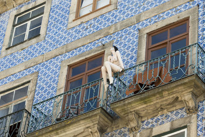Mannequin in balcony of building