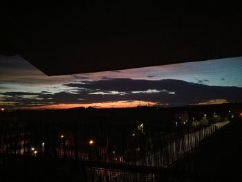 Illuminated cityscape against sky at night