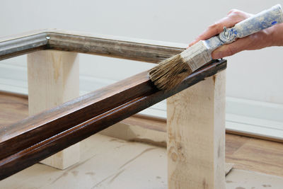 Close-up of person working on wood