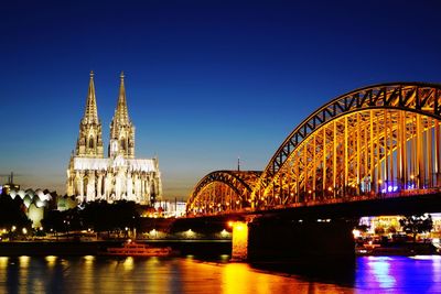 View of hohenzollern bridge and cologne cathedral at night