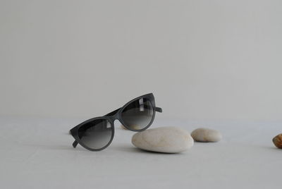 Close-up of sunglasses on table against white background