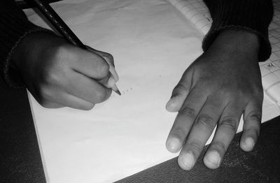 High angle view of people holding hands on table