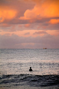 Scenic view of sea against orange sky