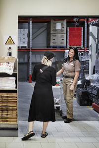 Women in warehouse talking
