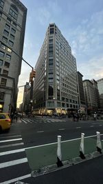 City street and modern buildings against sky