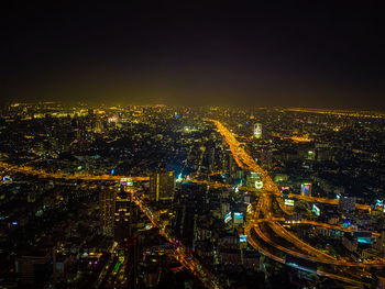 High angle view of city lit up at night