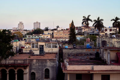 Buildings in city against clear sky