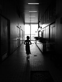 Rear view of woman walking on footpath