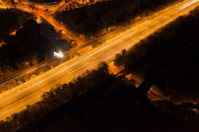 High angle view of light trails on road at night