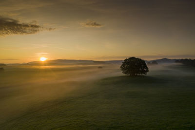 Scenic view of land against sky during sunset