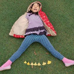 High angle view of girl lying on grass