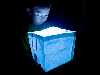 A child holding the glow box