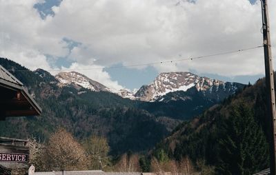 Panoramic shot of buildings and mountains against sky